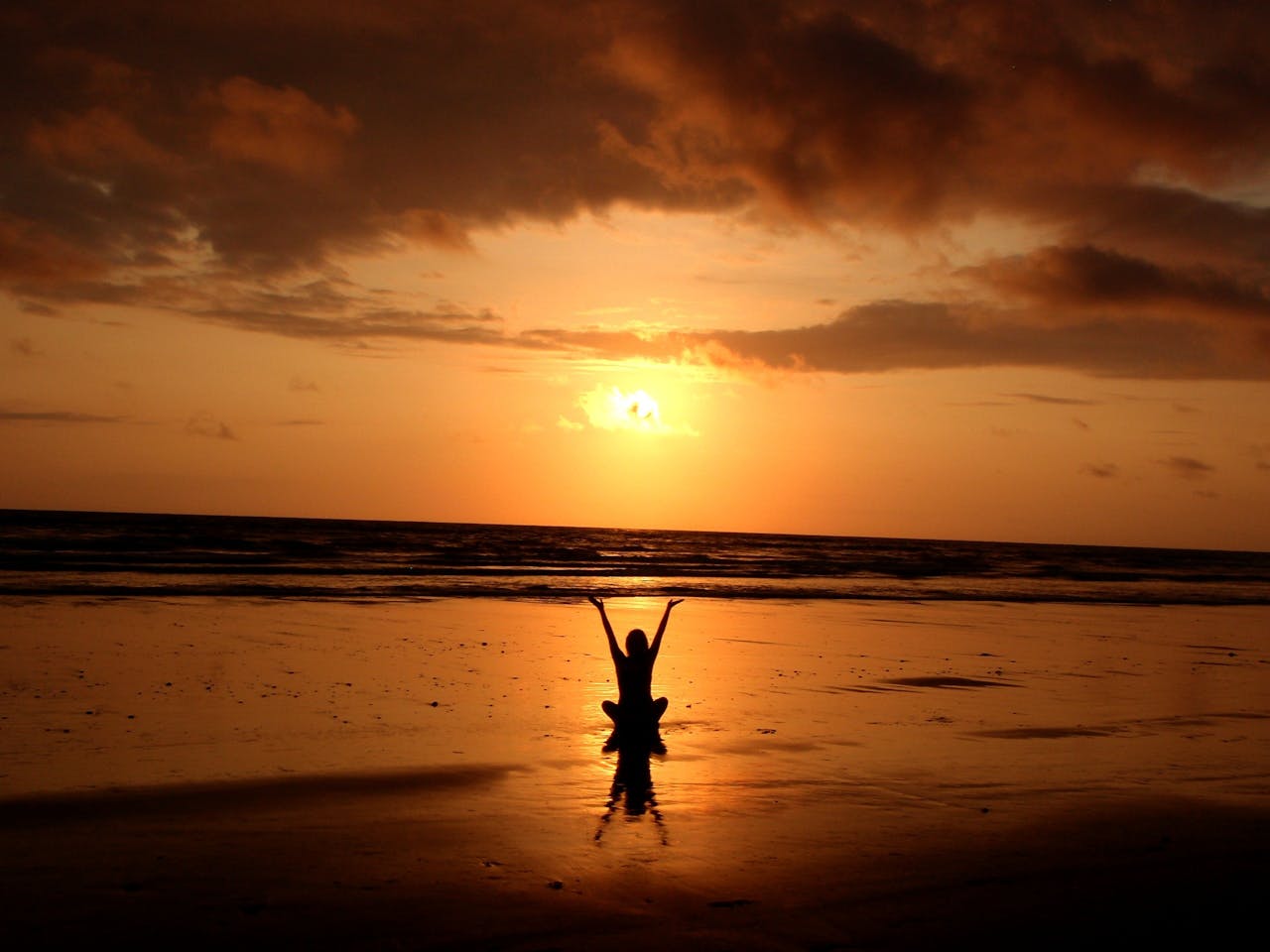 gallery-05 Peaceful meditation silhouette at sunset on a serene beach.
